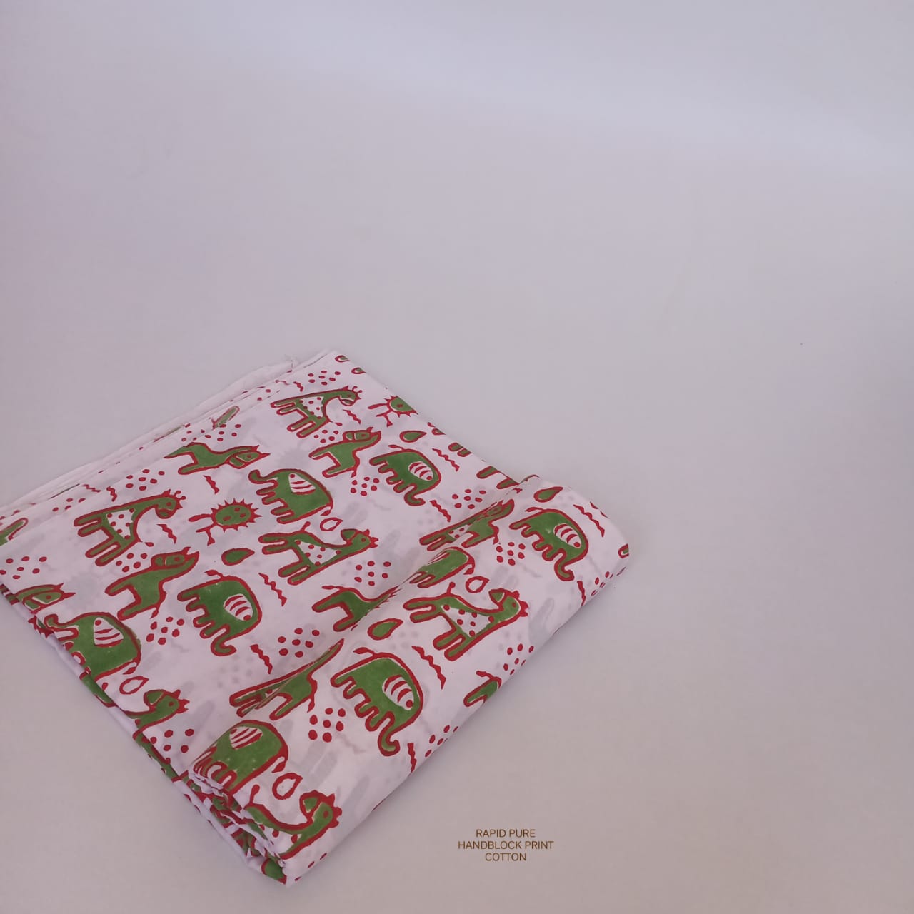 Artisan-crafted Jaipur Sanganeri Handblock Cotton Fabric in white and green with horse and camel print, ideal for boutiques, designers, and retailers.